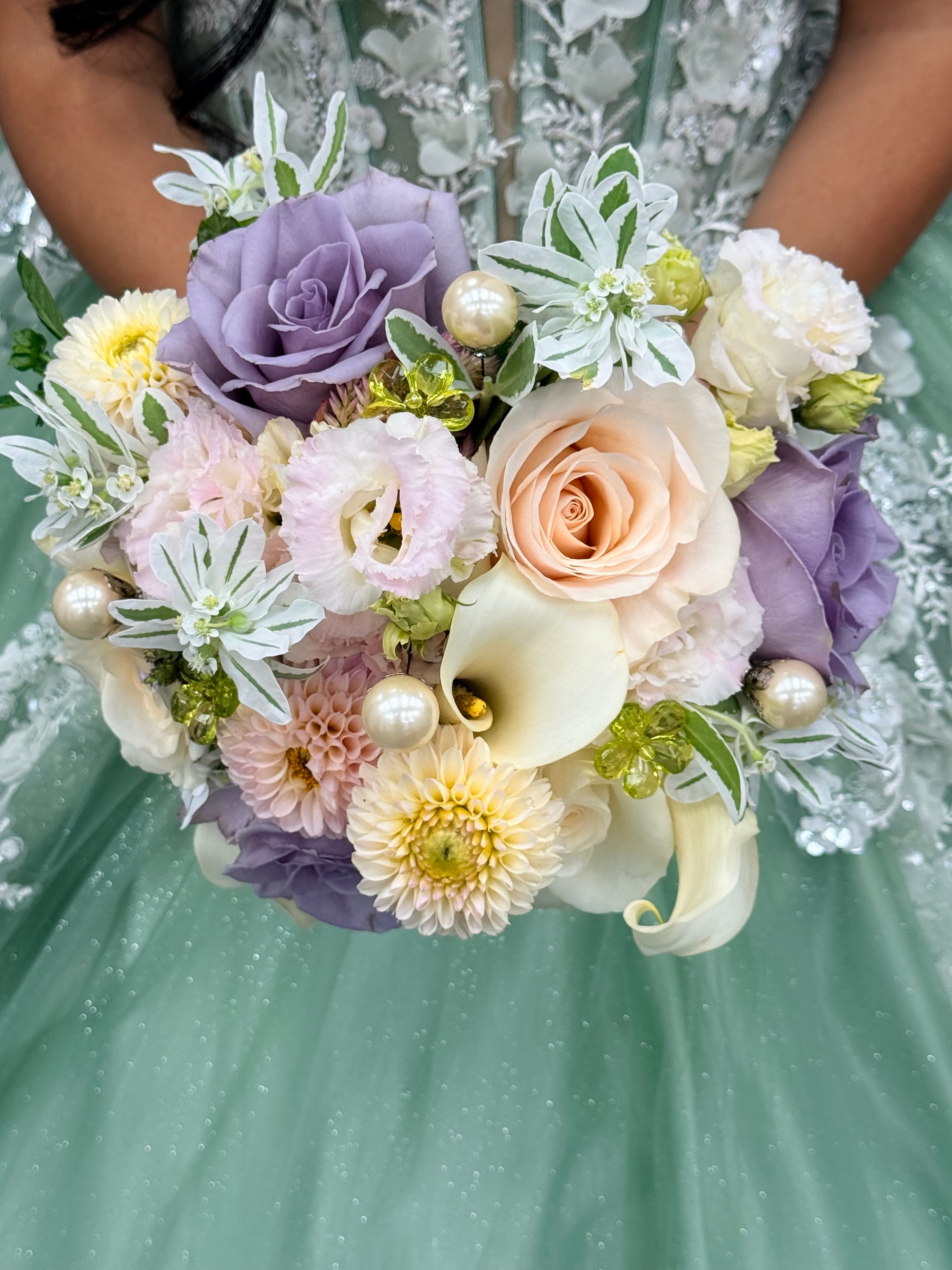 Quinceañera bouquet with lavender roses, peach rose, calla lilies, dahlias, and pearl accents
