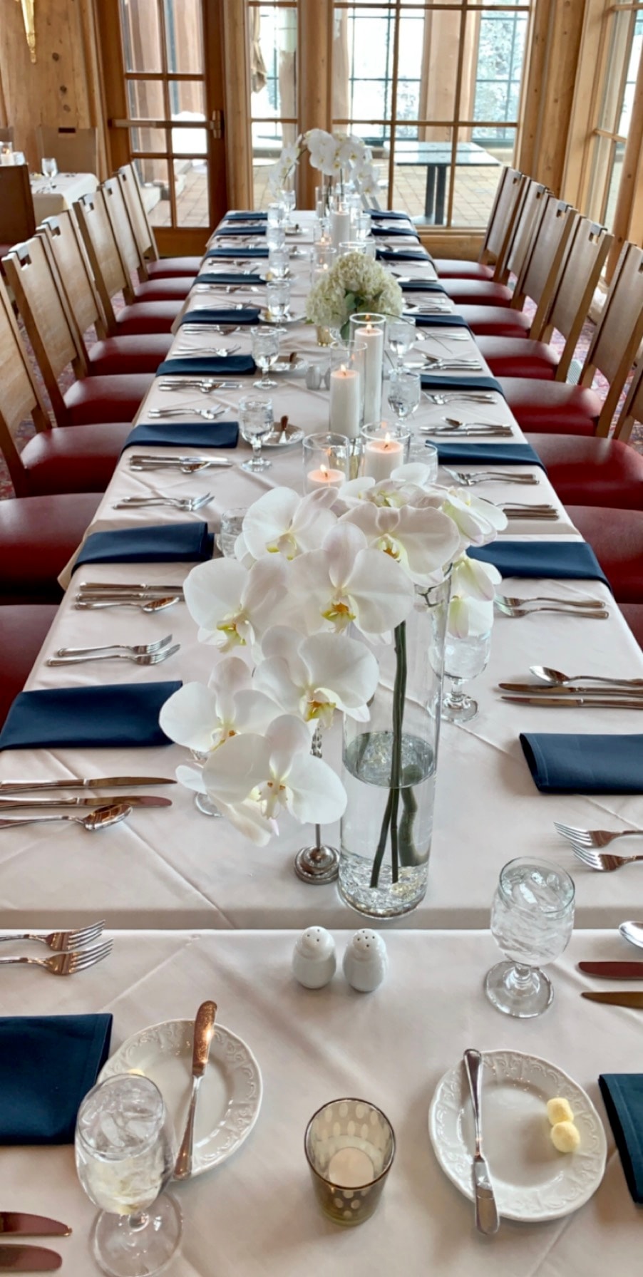 Elegant reception table with white orchid centerpieces