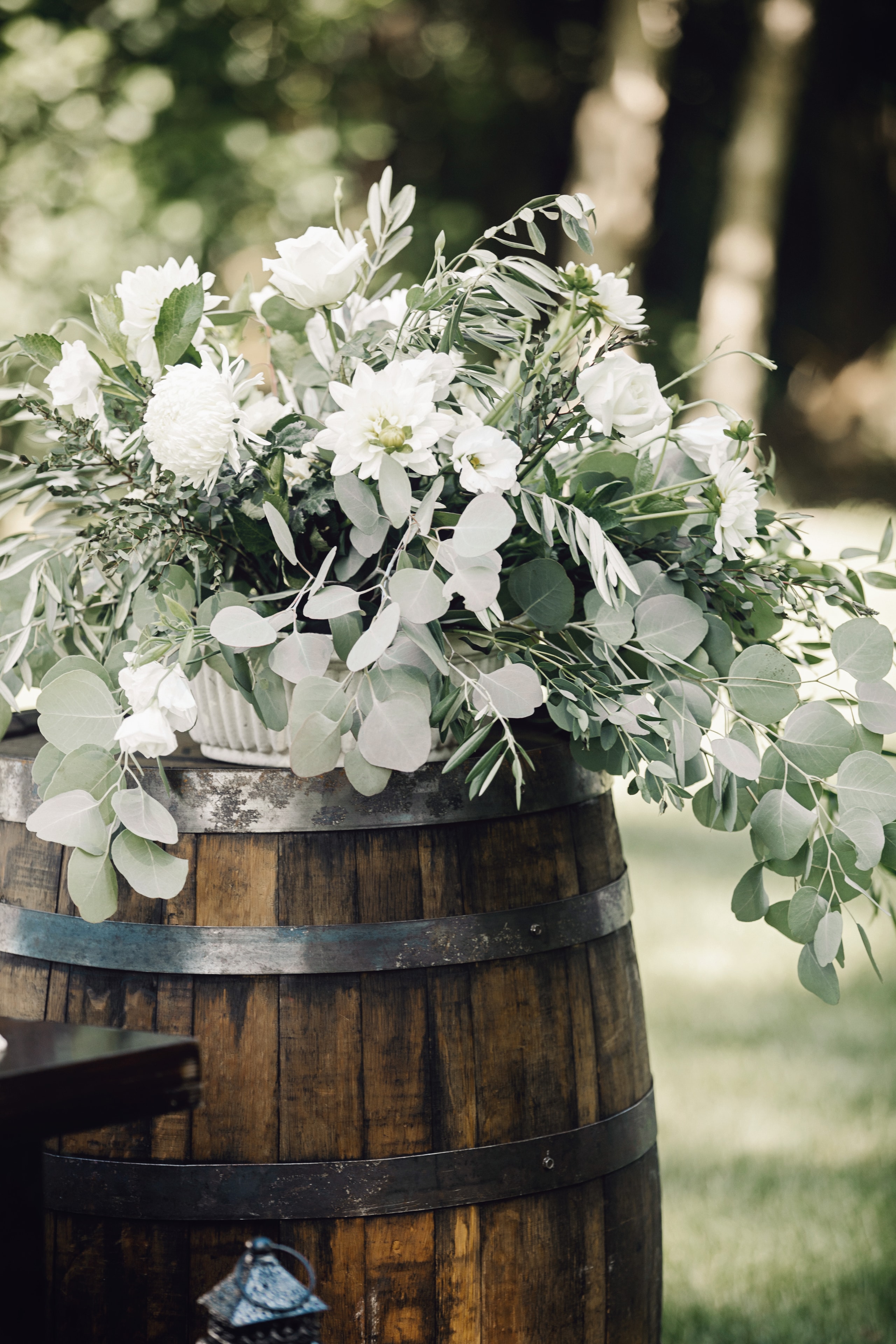 White flowers in rustic wooden barrel