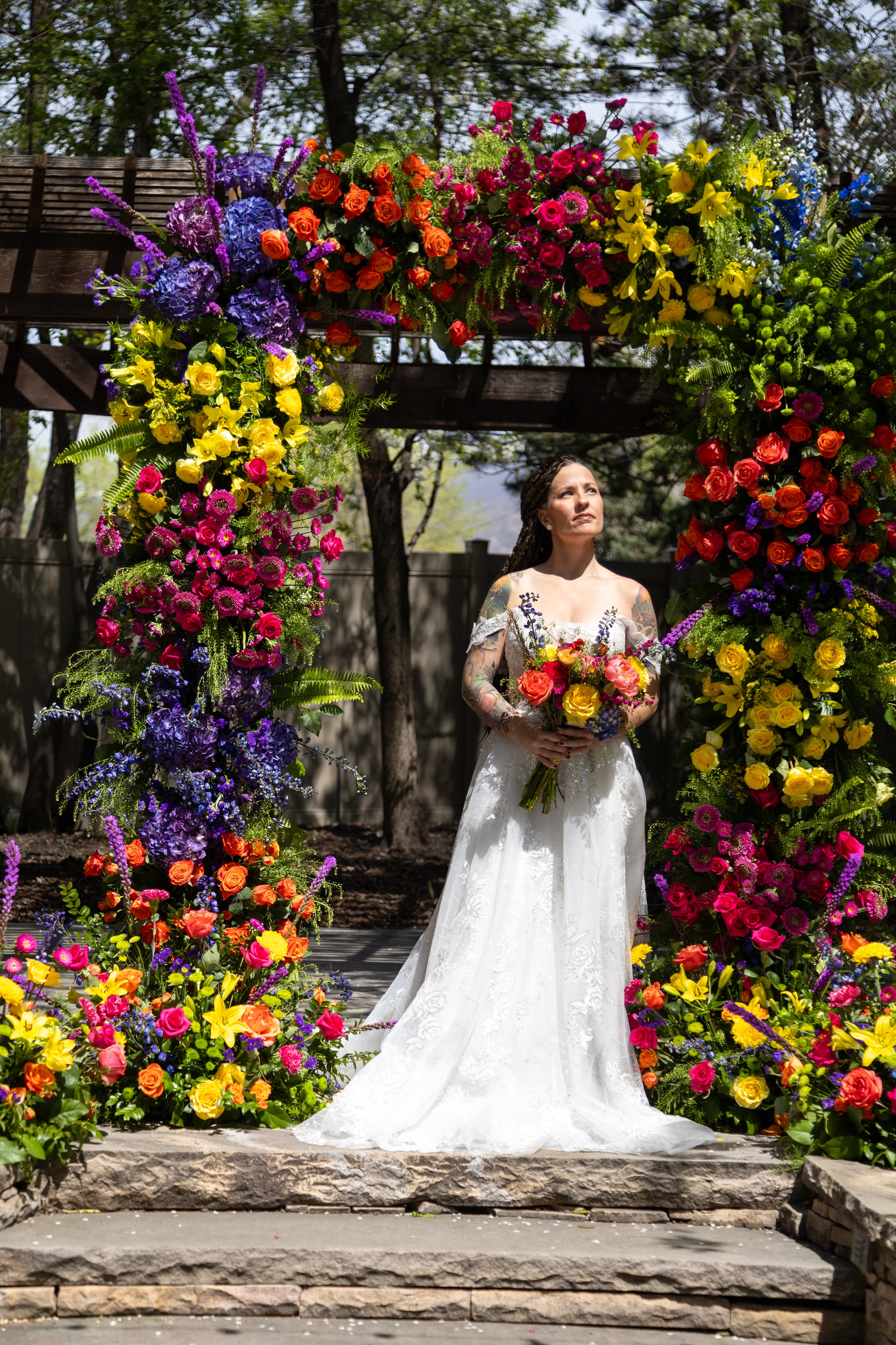 Lush green floral arch against stone background