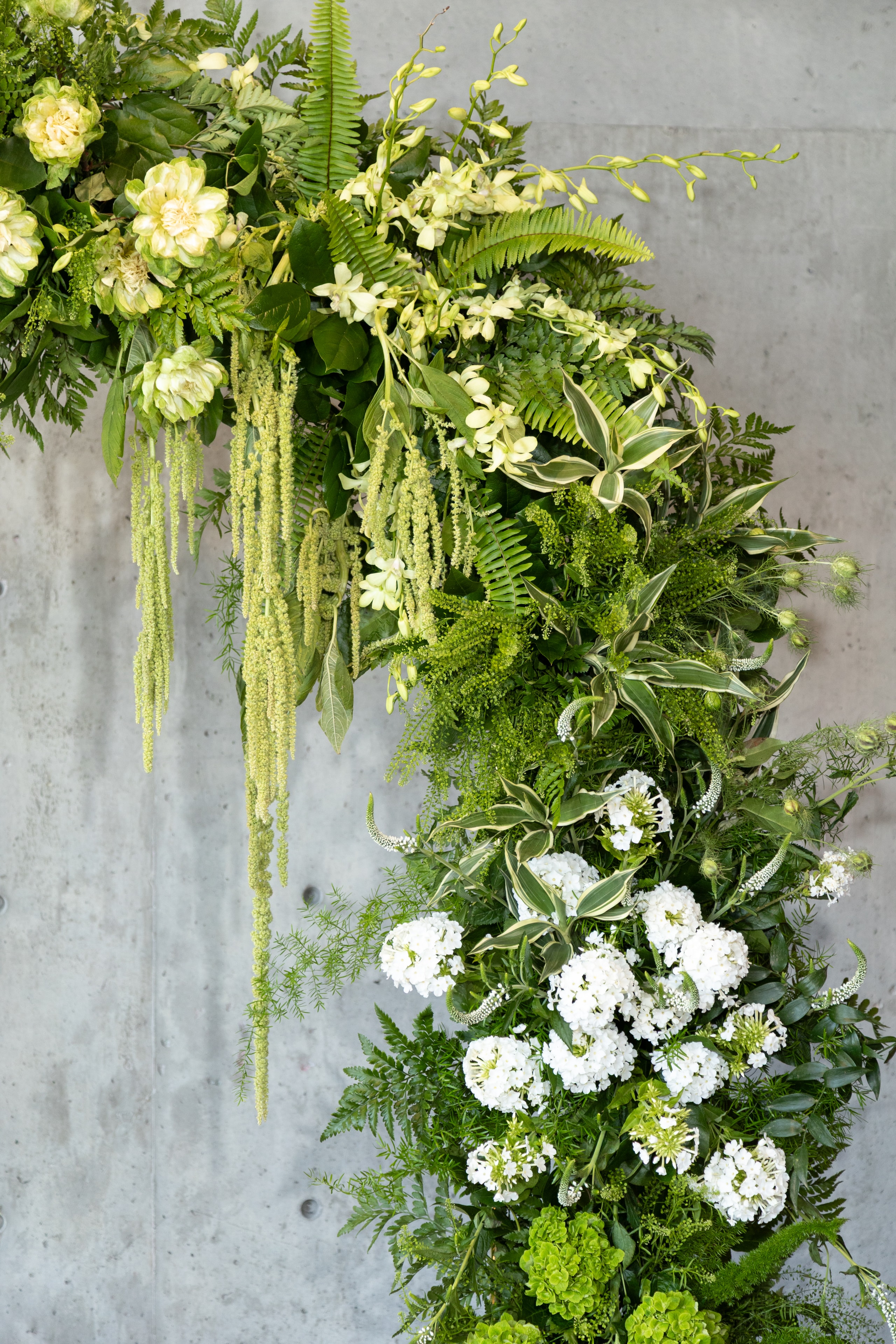 Ski resort wedding ceremony with white chairs and burgundy floral arch